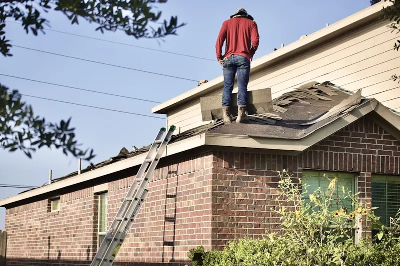 Professional roofer working on a residential roof in Salado Junction